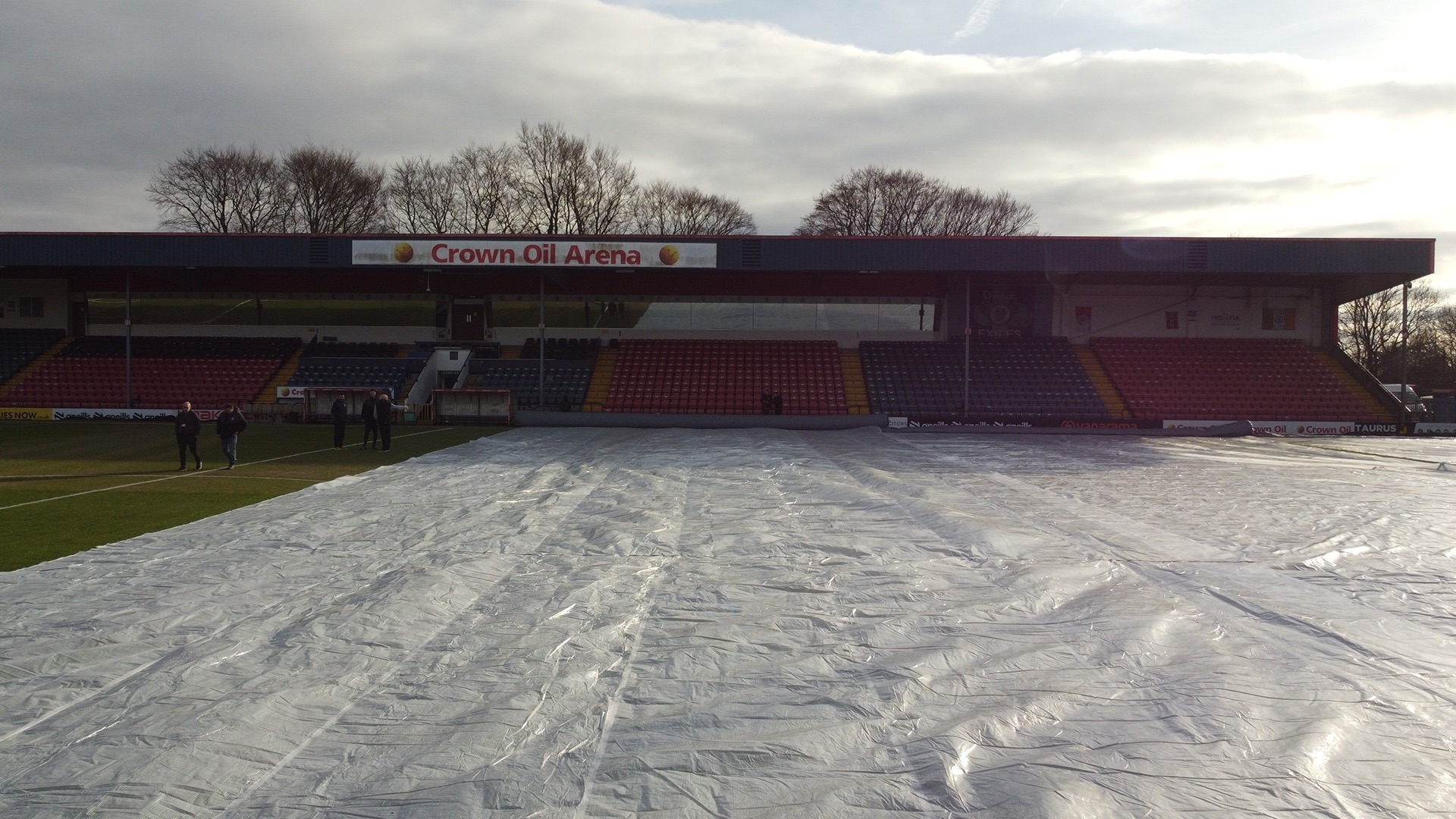 A picture of the rain covers being laid on the Crown Oil Arena pitch on Monday.